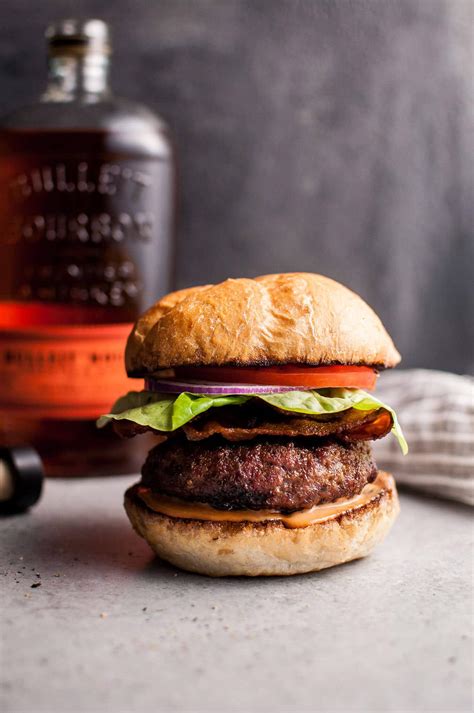 Bourbon and burger - In a medium bowl combine sliced peaches, bourbon and brown sugar. Set aside for 30-60 minutes to soak in flavor and release fruit juices. Reserve juiced in bowl. In a large bowl combine ground beef, thyme sprigs, pepper, salt, smoked paprika and garlic. Form mixture into 4-5 burger patties.